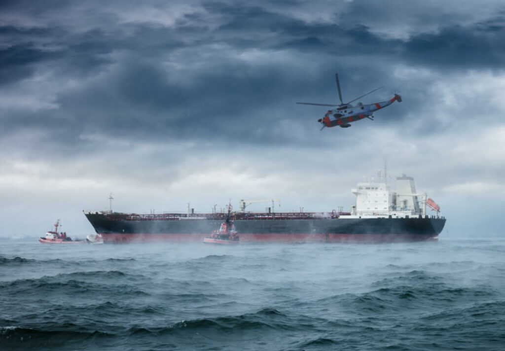 Image of a ship in rough water with a helicopter on a search and rescue mission